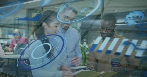 Multicultural team collaborating with augmented reality dashboards and tablets in modern office