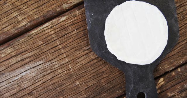 Rustic Cheese Wheel On Dark Slate Platter On Wooden Table - Download Free Stock Images Pikwizard.com