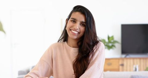 Smiling Woman Relaxing in Minimalist Living Room Interior