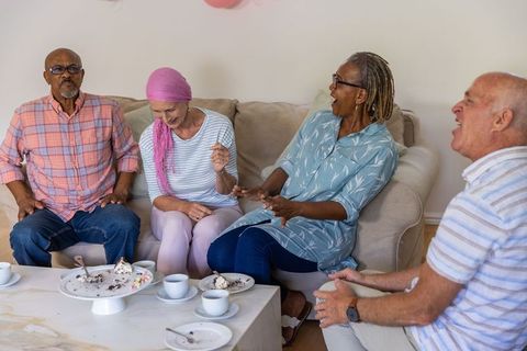Group of Diverse Senior Friends Enjoying Laugh on Sofa