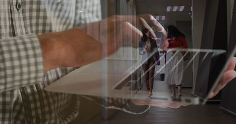 Laptop Use in Office Hallway with Colleagues