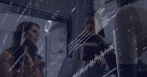 Women executives discussing data with transparent screens