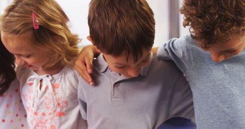 Diverse Children Embracing Friendship in Classroom Setting