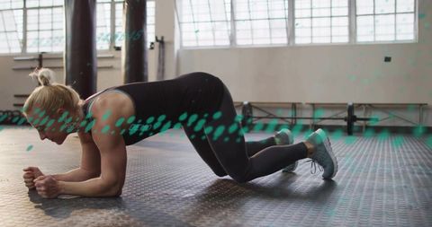 Woman performing forearm plank on gym floor with loaded barbell and teal overlay