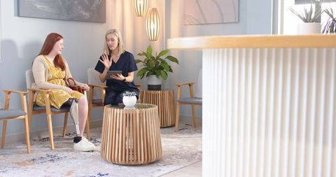 Woman with Prosthetic Leg Consulting Specialist in Modern Clinic