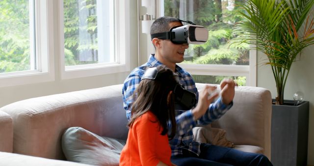 Father and Daughter Experiencing Virtual Reality Together on Couch - Download Free Stock Images Pikwizard.com