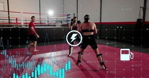 Female fighters sparring with real-time performance analytics overlay in boxing gym