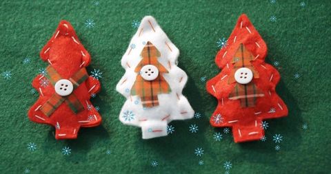 Handmade felt christmas trees with plaid appliques, button embellishments, stitched edges