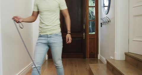 Young Man Holding Leash in Minimalistic Home Foyer