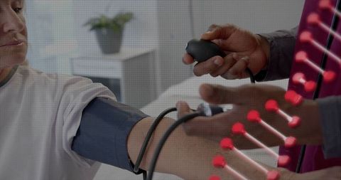 Clinician measuring patient blood pressure at home with manual sphygmomanometer