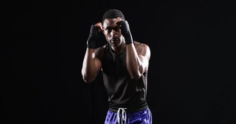 Determined Boxer in Fighting Stance Highlights Intensity of Training