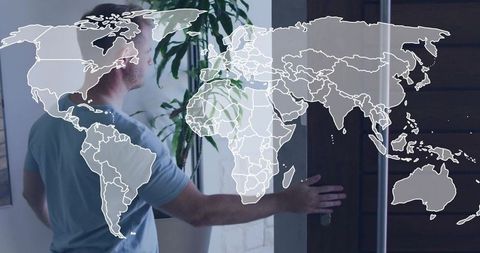 Reaching man opening sliding door with world map overlay and indoor plant for global travel concept