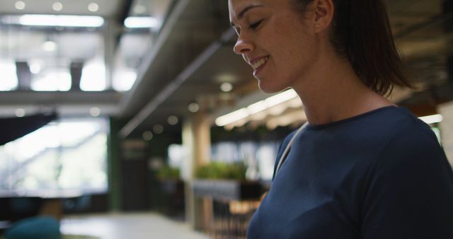 Smiling Woman in Modern Office Brightly Lit Environment - Download Free Stock Images Pikwizard.com