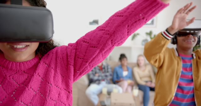 Teenagers are immersing themselves in a virtual reality gaming experience while at a home party. Perfect for depicting social interactions, modern technology usage, entertainment at gatherings, and innovative gaming experiences.