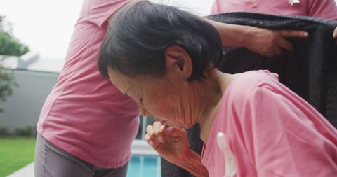 Granddaughter Helping Elderly Grandmother with Blanket Outdoors