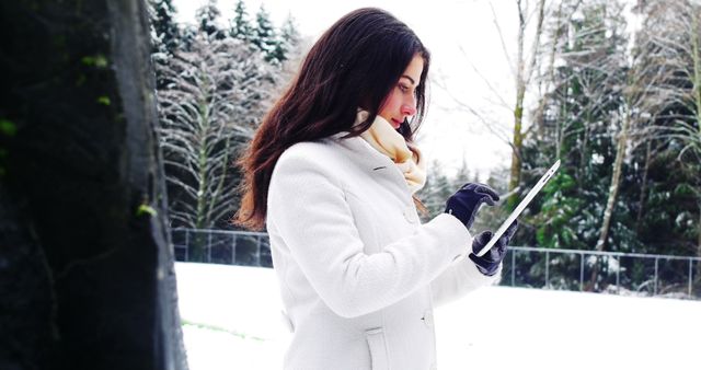 Woman Using Tablet Outdoors During Winter - Download Free Stock Images Pikwizard.com