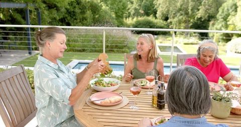 Group of Friends Enjoying Outdoor Meal on Sunny Day