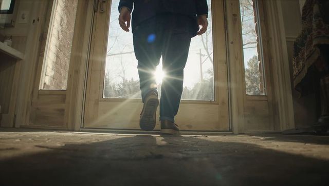 Backlit sunflare through glass doorway walking toward outside stepping into foyer