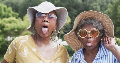 Senior African American Women Expressing Joyful Humor in Outdoor Garden