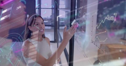 Businesswoman presenting interactive data on glass whiteboard with neon analytics overlay