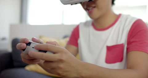 Asian college student engaged in virtual reality gaming