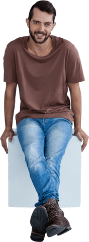 Smiling casual male model sitting wearing transparent t-shirt