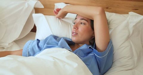 Woman Relaxing in Comfortable Bedroom Setting