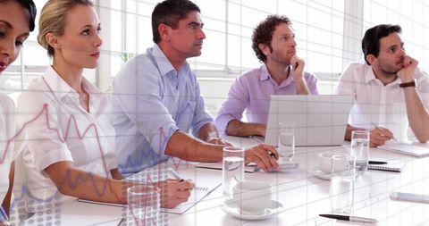 Business Team Analyzing Financial Data in Conference Room
