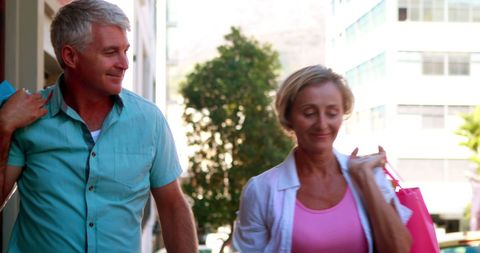 Cheerful Mature Couple Shopping Outdoors on Sunny Day - Download Free Stock Images Pikwizard.com