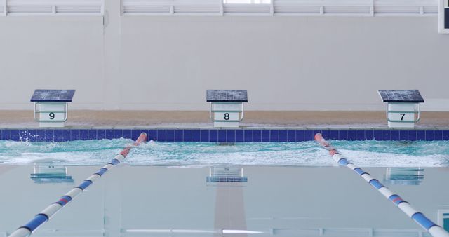 Empty Indoor Swimming Pool with Starting Blocks and Lane Dividers - Download Free Stock Images Pikwizard.com