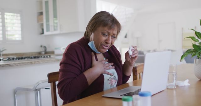 Older Woman Holding Chest during Telehealth Appointment - Download Free Stock Images Pikwizard.com