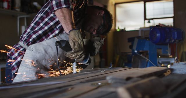 Carpenter in workshop grinding wooden plank with sparks flying - Download Free Stock Images Pikwizard.com