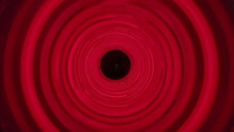 Immersive Red Concentric Tunnel Emitting LED Glow with Dark Central Aperture