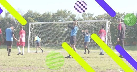 Youth soccer players competing for ball at goal on sunny pitch with neon graphic overlay