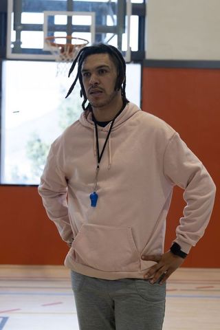 Athletic Coach on Indoor Basketball Court in Casual Sportswear