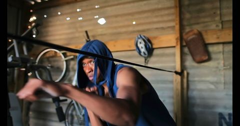 Focused Boxer Training with Resistance Bands in Rustic Gym