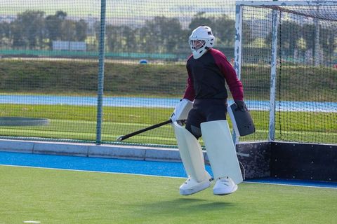 Field Hockey Goalkeeper Ready for Action on Turf