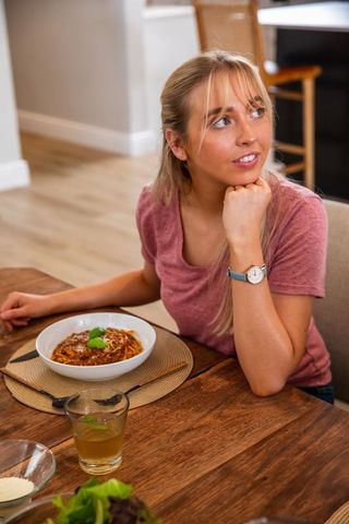 Young Woman Enjoying Lunch at Home with Cozy Atmosphere
