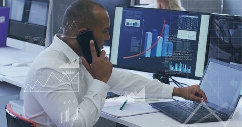 Financial Analyst Examining Data on Multiple Screens in Modern Office