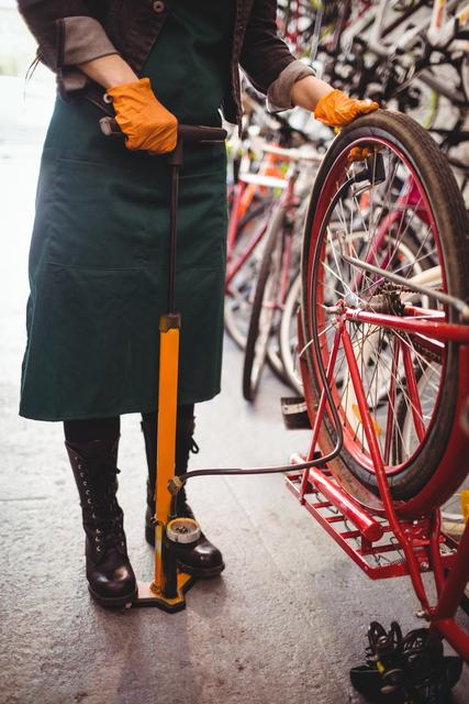 This image is useful for illustrating professional bicycle maintenance, promoting bike repair services, or showcasing the atmosphere in a repair workshop. It highlights the technical aspect of bike care, useful for websites, brochures, and advertisements related to cycling, transportation, and sporting goods.