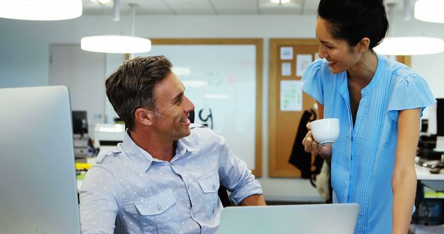 Coworkers Smiling and Conversing in Modern Office - Download Free Stock Images Pikwizard.com