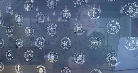Pensive professional in modern workspace with technology interface