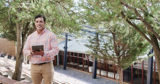 Confident Businessman Holding Tablet in Outdoor Setting - Download Free Stock Images Pikwizard.com