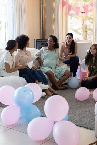 Diverse Women Celebrating Baby Shower with Pink and Blue Decor