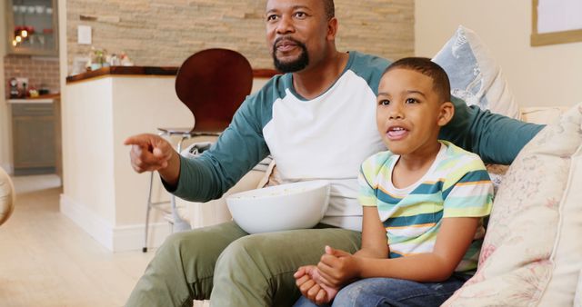 Father and Son Watching TV Together in Living Room - Download Free Stock Images Pikwizard.com