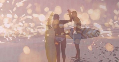 Ocean Sunset High-Five for Jubilant Surfers on Sandy Beach