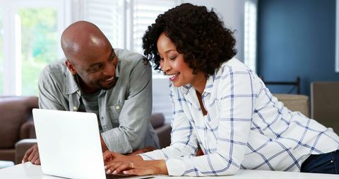 Couple Smiling and Browsing Laptop Together - Download Free Stock Images Pikwizard.com