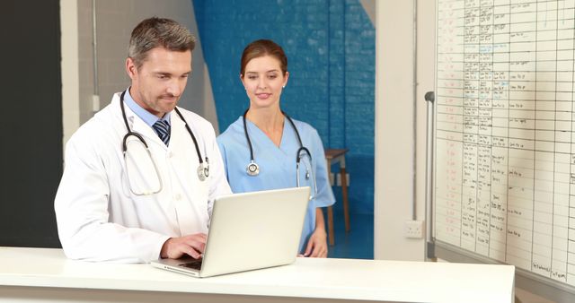 Doctors Collaborating in Hospital Office Using Laptop - Download Free Stock Images Pikwizard.com