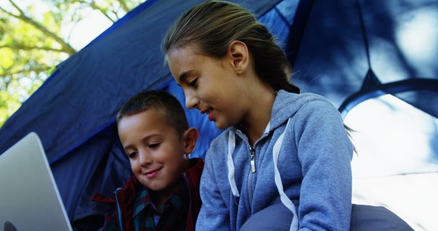 Two Happy Kids Using Laptop Outdoors at Campsite - Download Free Stock Images Pikwizard.com