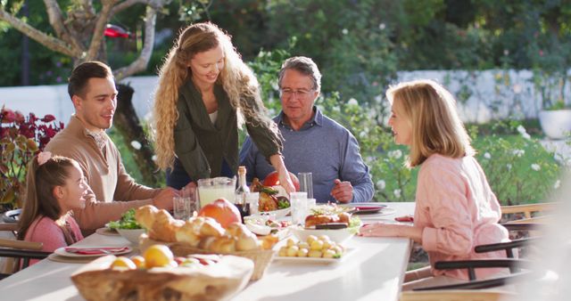Image of happy caucasian parents, daughter and grandparents serving food at table before meal. Family, domestic life and togetherness concept digitally generated image.
